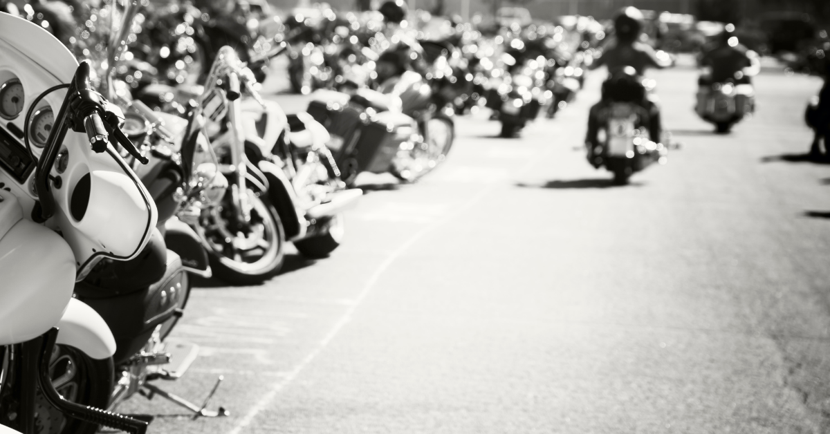 group of motorcycles and riders in black and white